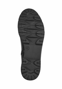 Black rubber shoe sole featuring a textured, patterned grip with distinct treads and raised accents for enhanced traction and durability.