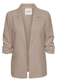 Blazer beige pour femme avec manches trois-quarts froncées et col à revers, ouverture devant et étiquette indiquant "soaked" à l’intérieur du col.