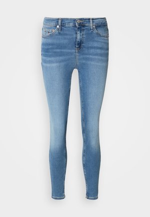Skinny jeans in light blue denim, featuring a classic five-pocket design, button closure, and subtle fading for a distressed look.