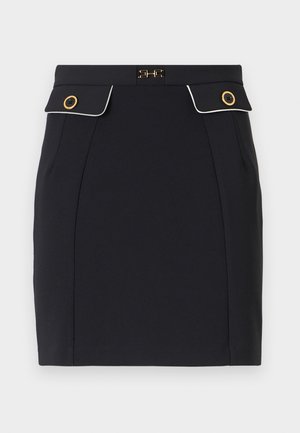 Navy mini skirt made of smooth fabric with gold-tone button accents, flat front pockets, and contrasting white piping along the edges.