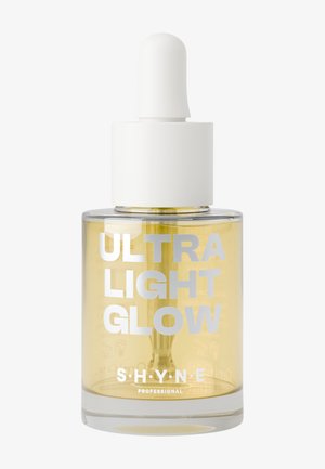 Flacon compte-gouttes en verre transparent avec un bouchon blanc ; contient un sérum jaune clair. Texte argenté en gras : "ULTRA LIGHT GLOW" et nom de la marque "S'HYNE."