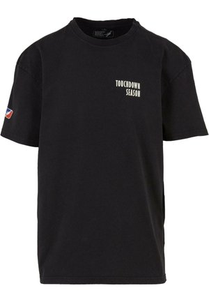 Black cotton t-shirt featuring short sleeves, a crew neck, and the text "TOUCHDOWN SEASON" in white on the front; logo patch on the sleeve.