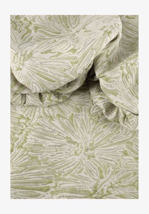 Soft green fabric with raised floral and leaf patterns creating textured, swirling shapes across the surface.