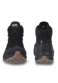 Black hiking shoes with a high top, featuring durable fabric, rugged soles, and a reinforced toe. Minimalist design with sturdy laces.