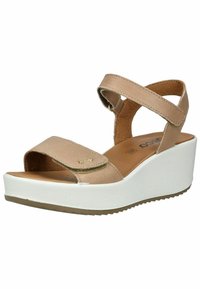 Beige sandal with cross straps, wide toe area, gold accent, cushioned insole, and a white wedge sole with a textured bottom.