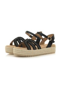 Sandali neri con cinturini, dettagli intrecciati, suola intermedia in juta stile espadrilla, suola in gomma piatta e cinturino alla caviglia regolabile.