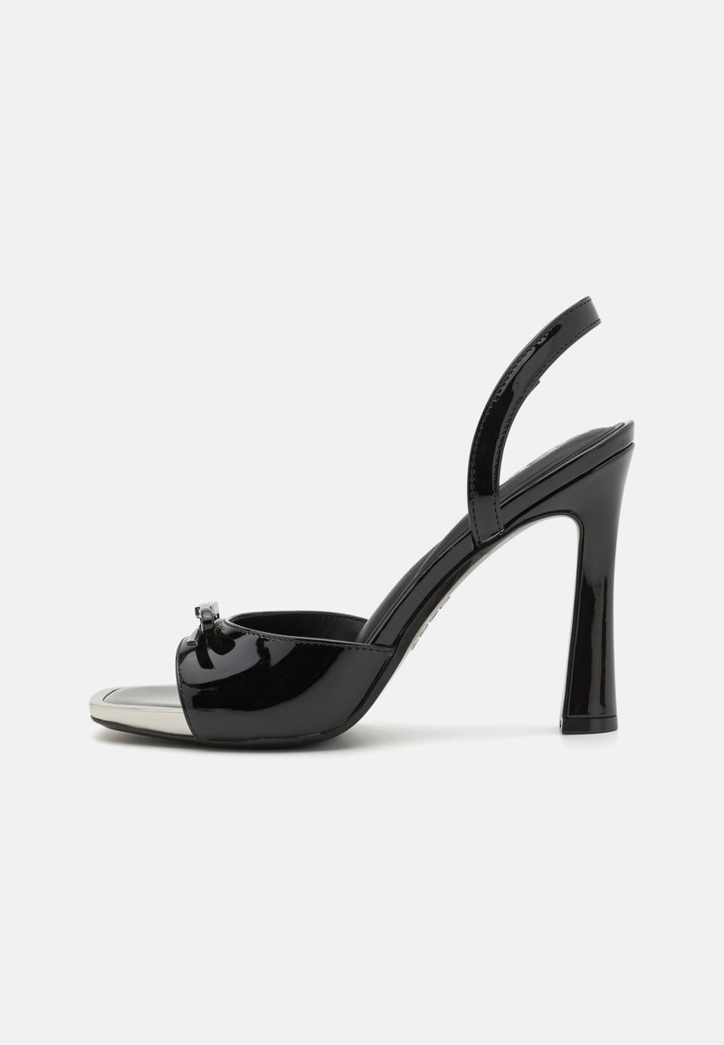 Black patent leather high-heel sandal with open toe, slingback strap, silver metallic toe cap, and decorative buckle detail.