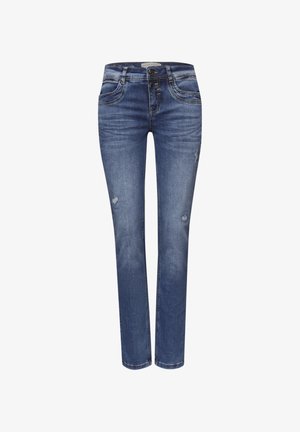 Jean en denim bleu coupe slim avec légère usure sur les cuisses, fermeture avant par bouton et zipper, et design classique à cinq poches.