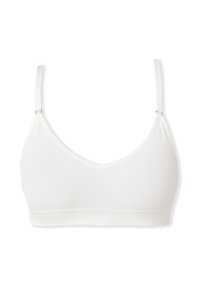 Bralette blanca con un diseño suave y sin costuras, tirantes ajustables y una banda gruesa acanalada en la parte inferior. Sin relleno ni varilla.