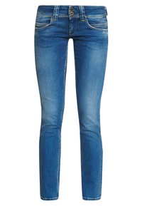 Smala jeans i medelblå denim, med två framfickor, två bakfickor och en tvåknapps midjeslutning. Faded-sektioner ger textur.