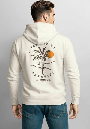 Beige Kapuzenpullover mit Palmbaumgrafik, orangefarbener Sonne und dem Text "NIMM MICH IN DAS PARADIES." Mit einer Kordelzugkapuze und gerippten Bündchen.