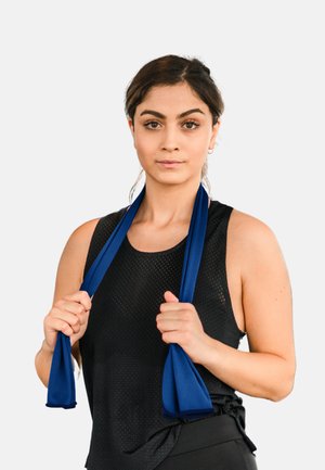 Blue resistance bands are held by a person in a black mesh tank top. The bands are textured and curved, adding grip for exercises.