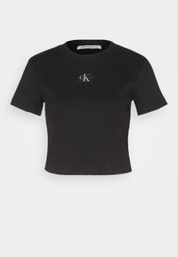 Černé zkrácené tričko vyrobené z žebrované látky. Má malé bílé a šedé logo Calvin Klein na přední straně. Krátké rukávy, kulatý výstřih.