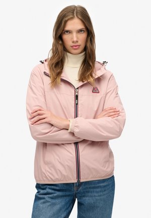 Light pink waterproof jacket featuring a zippered front, hood, and contrasting blue-red trim. Material has a smooth, sleek texture.