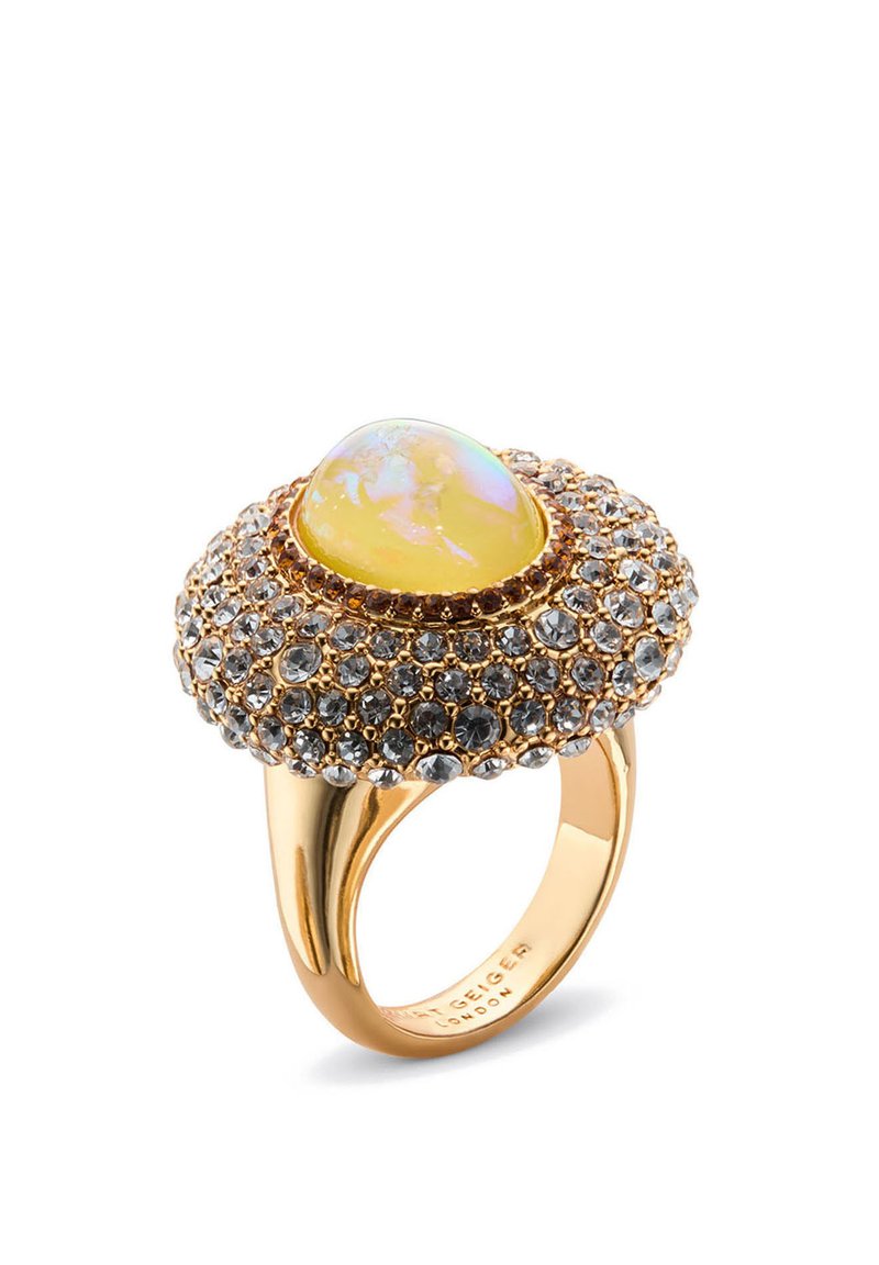 Gold ring featuring a large yellow opal stone surrounded by small gray and clear crystals, with a textured, domed design.