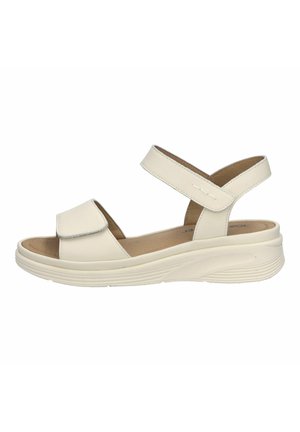 White leather sandal featuring a closed toe and two adjustable cross-straps. The lightweight sole has a textured design for added grip.