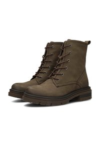 Bottines en cuir marron avec bout rond, fermeture à lacets, œillets métalliques, semelle en caoutchouc et finition texturée. Rembourrage épais et tirette.