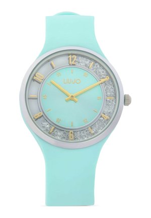 Orologio da polso in silicone azzurro chiaro con lancette dorate, indici delle ore dorati, anello interno decorato con cristalli e logo "LIU·JO" sul quadrante.