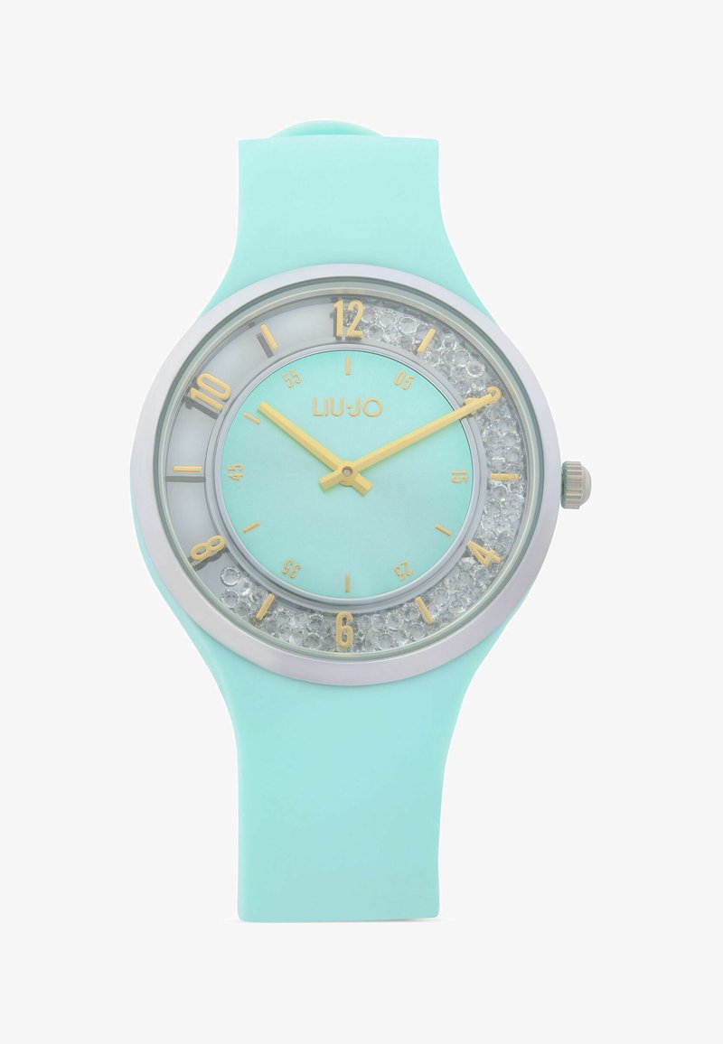 Montre-bracelet en silicone bleu clair avec aiguilles dorées, index des heures dorés, anneau intérieur orné de cristaux et logo "LIU·JO" sur le cadran.
