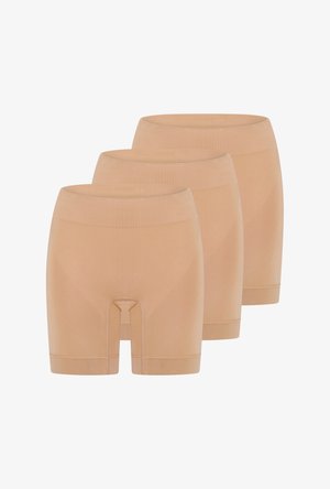 Trois shorts de compression couleur chair sans coutures, avec des tailles hautes, disposés en pile de façon décalée.