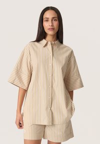 Striped, beige short-sleeve shirt with a button front, featuring wide sleeves and a relaxed fit. Smooth fabric with vertical stripes.