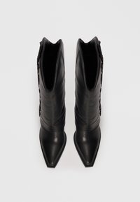 Black leather ankle boots with a pointed toe, smooth finish, and textured accents along the side. Sleek silhouette with a fitted shaft.