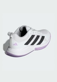 White athletic shoe with a mesh upper, black three-stripe design, and purple accents on the sole. Features a pull tab at the heel.