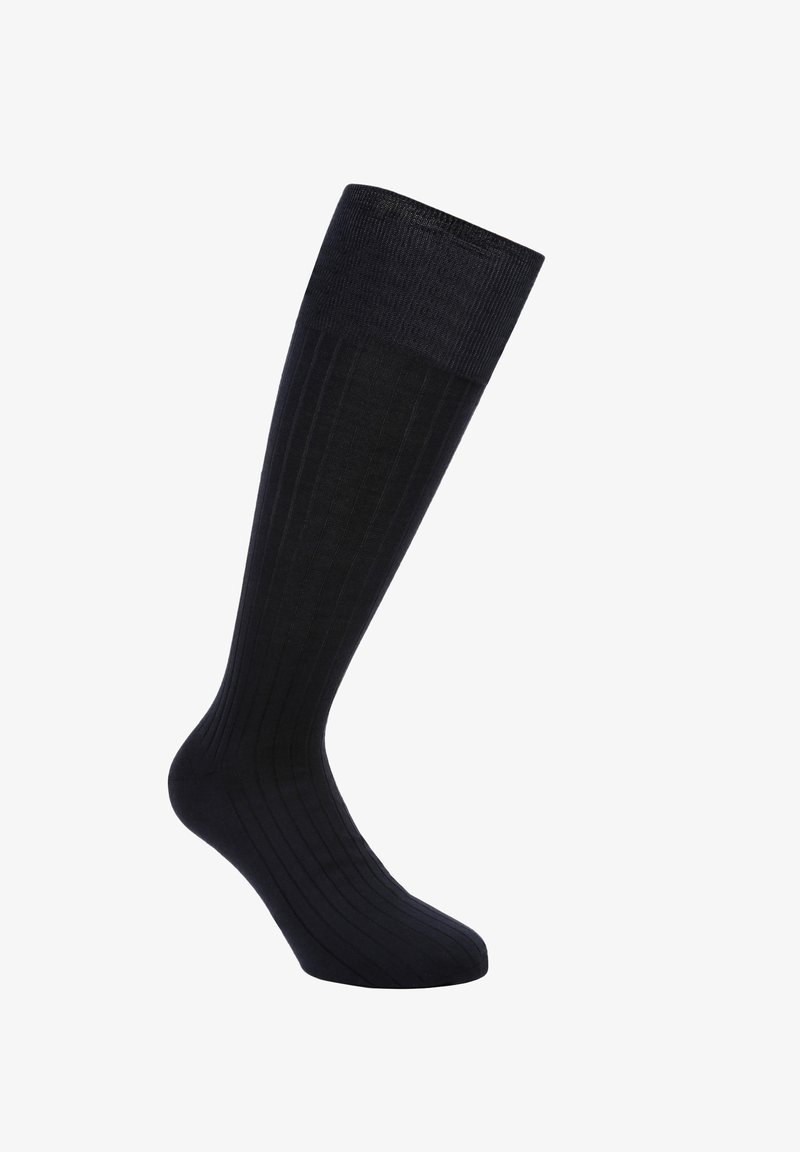 Calze nere fino al ginocchio con una texture a coste, realizzate in un materiale morbido. Presentano un colore uniforme e un design affusolato per una vestibilità aderente.