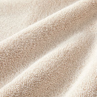 Μπεζ υφασμάτινη υφή με ένα χνουδωτό, απαλό επιφάνεια, που διαθέτει πυκνούς, ομοιόμορφα κατανεμημένους βρόχους. Απαλή εμφάνιση με ζεστό χρωματικό τόνο.