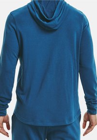 Felpa con cappuccio blu realizzata in un morbido tessuto elasticizzato, con maniche lunghe, cappuccio regolabile e orlo arrotondato. Nessun motivo visibile o accessorio.