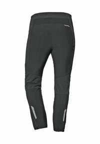 Schwarze technische Hosen mit sich anpassendem Schnitt, ausgestattet mit reflektierenden Akzenten und Einsätzen für verbesserte Beweglichkeit. Weiches Material mit matter Oberfläche.