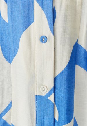 Button-up shirt with blue and white abstract pattern, made of lightweight fabric; features two buttons and visible stitching detail.