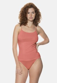 Peach-colored, stretchy tank top with thin straps and a slim fit. Paired with matching low-rise bikini bottoms. Smooth texture and minimal design.