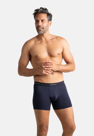 Boxers ajustés en coton bleu marine avec une ceinture à logo, présentant une coupe ajustée, des coutures plates et une poche pour le soutien.