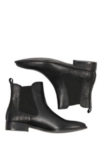 Cizme Chelsea din piele neagră, cu panouri laterale elastice negre texturate. Au un tocul jos de tip bloc și vârful neted.
