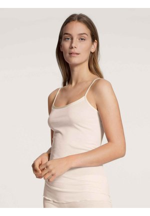 Cream tank top with thin straps, made from a soft, stretchy fabric. Features a scoop neckline and seamless edges for comfort.