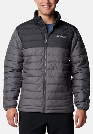 Men's Columbia puffer jacket featuring a black top section and gray quilted lower section, made of insulated material with zippered pockets.