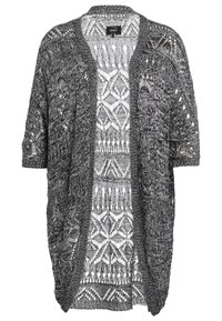 Öppen cardigan i svart och grå stickad kvalitet. Har en spetsdesign med geometriska mönster och korta ärmar. Lättviktig och andningsbar textur.