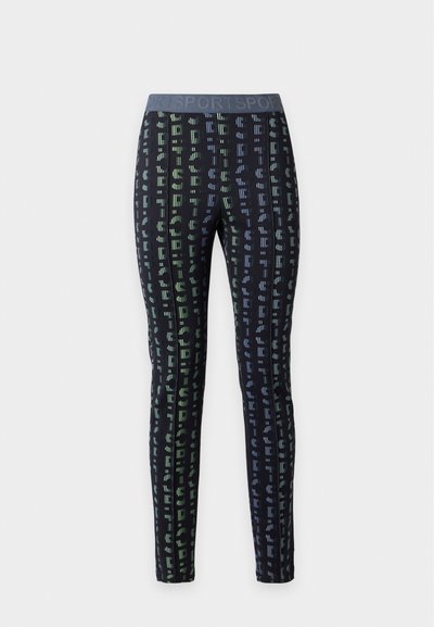 Leggings noirs longueur totale avec motifs abstraits verticaux multicolores et une large ceinture étiquetée "SPORT" en gris.