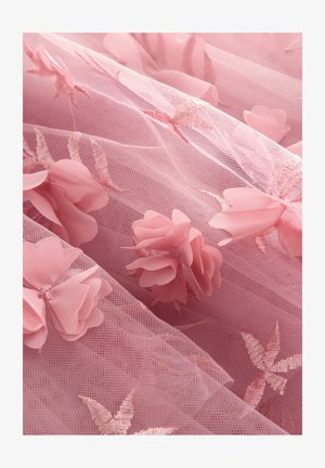 Pink tulle fabric featuring floral appliqués and embroidered leaf patterns, with a soft, sheer texture and layered appearance.