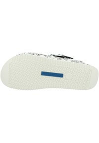 Witte zool met een gestructureerd grippatroon. Bovenwerk heeft een zwart-wit paisley ontwerp. Blauwe 'BIRKENSTOCK' logo aan de zijkant.