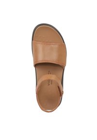 Tan leather sandal with two wide straps, cushioned footbed featuring small dots for grip, and a durable black outsole.