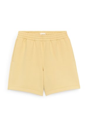 Beige casual korte broek met elastische tailleband, zijzakken en rechte zoom, plat gelegd op een witte achtergrond.