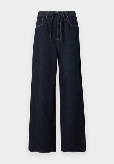 Mørkeblå vide denimbukser med snøring i livet, standard fem-lomme design og kontrasterende sømdetaljer.