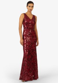 Longo abito da sera bordeaux con silhouette aderente, adornato con paillettes e motivi floreali, caratterizzato da una profonda scollatura a V e design senza maniche.