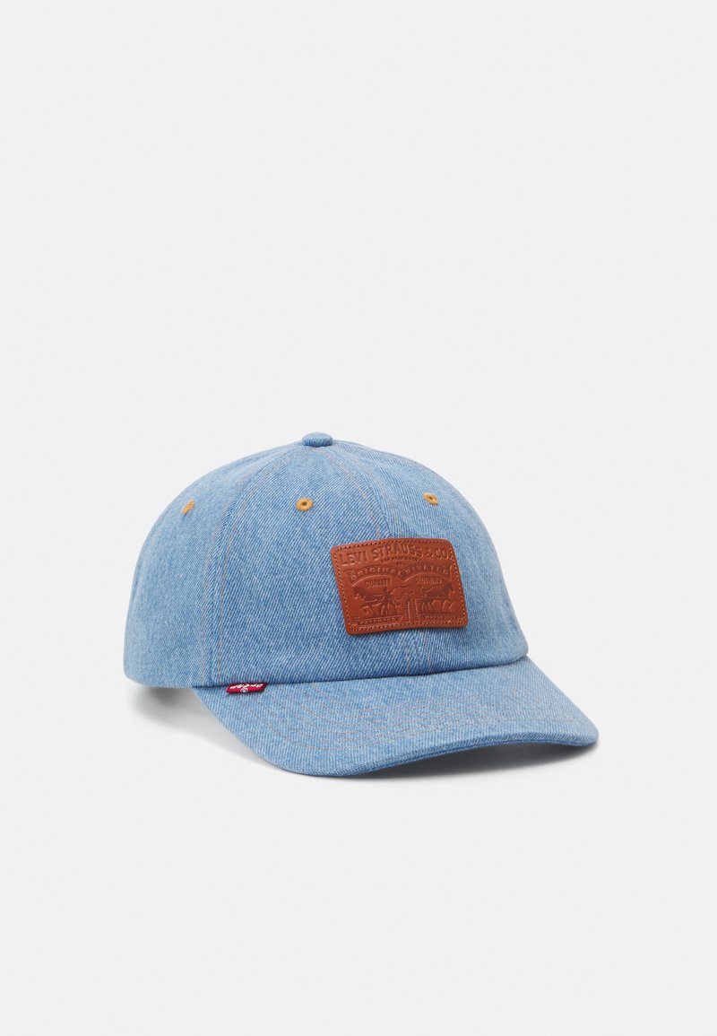 Boné de beisebol em denim azul com um patch de couro castanho com design em relevo, costura amarela e aba curva.