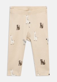 Μπεζ ριμπ κολάν με διάσπαρτο σχέδιο ζώων, όπως καμηλοπαρδάλεις και γάτες, σε καφέ και λευκές αποχρώσεις. Απαλό υλικό και ελαστική μέση.