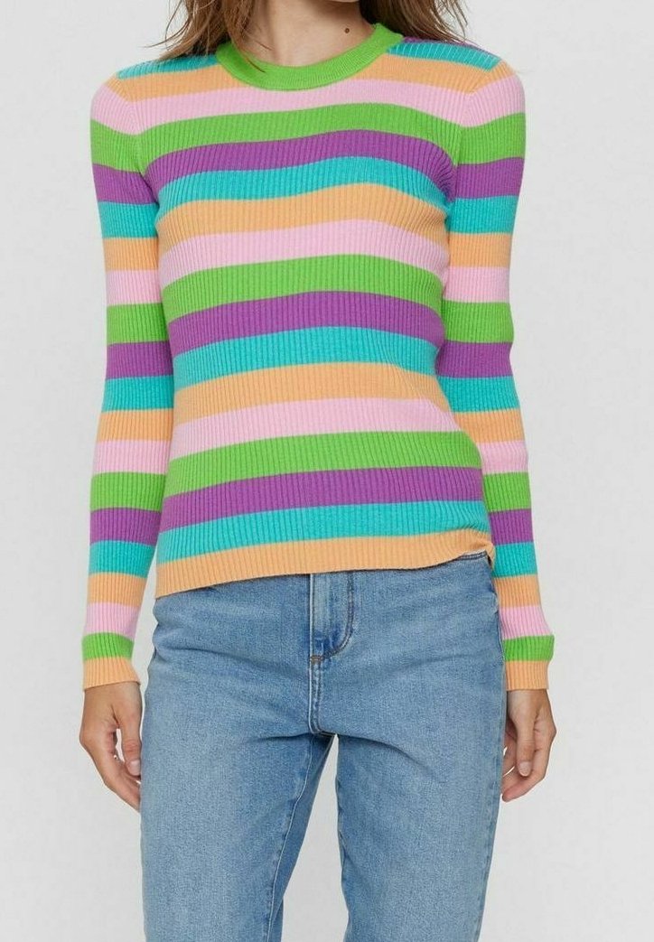 Femme portant un pull à manches longues ajusté et côtelé avec des rayures horizontales vertes, violettes, turquoise, pêche et roses, associé à un jean bleu.