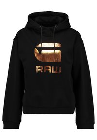 Sudadera negra con un logo y texto metálico en color cobre "RAW" en la parte frontal, con capucha regulable y puños y dobladillo de canalé.