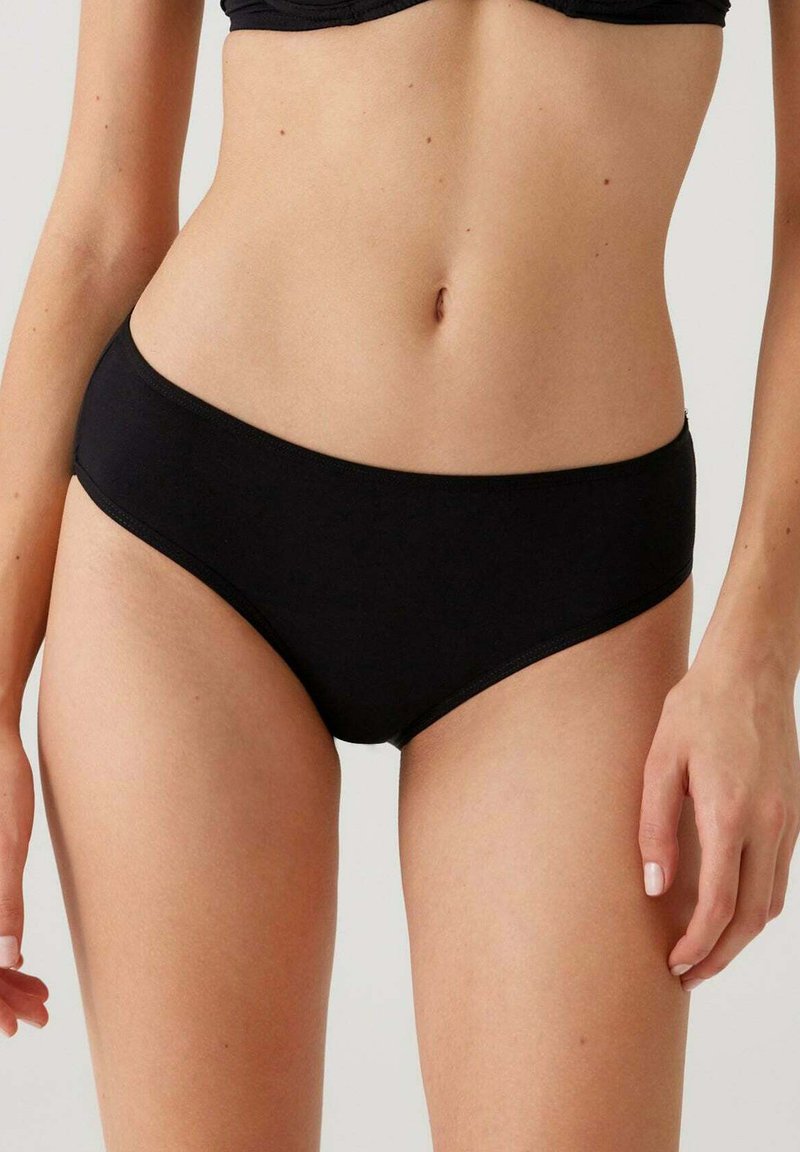 Zwarte katoenen bikini slipjes met een gladde textuur, laag uitgesneden ontwerp en contrasterende stiksels langs de randen.